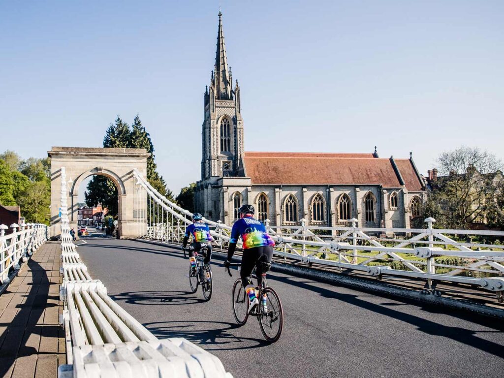 Riders crossing bridge